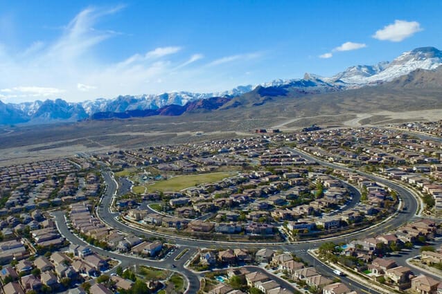 Aerial photo taken over Summerlin with snow-capped mountains in the background.