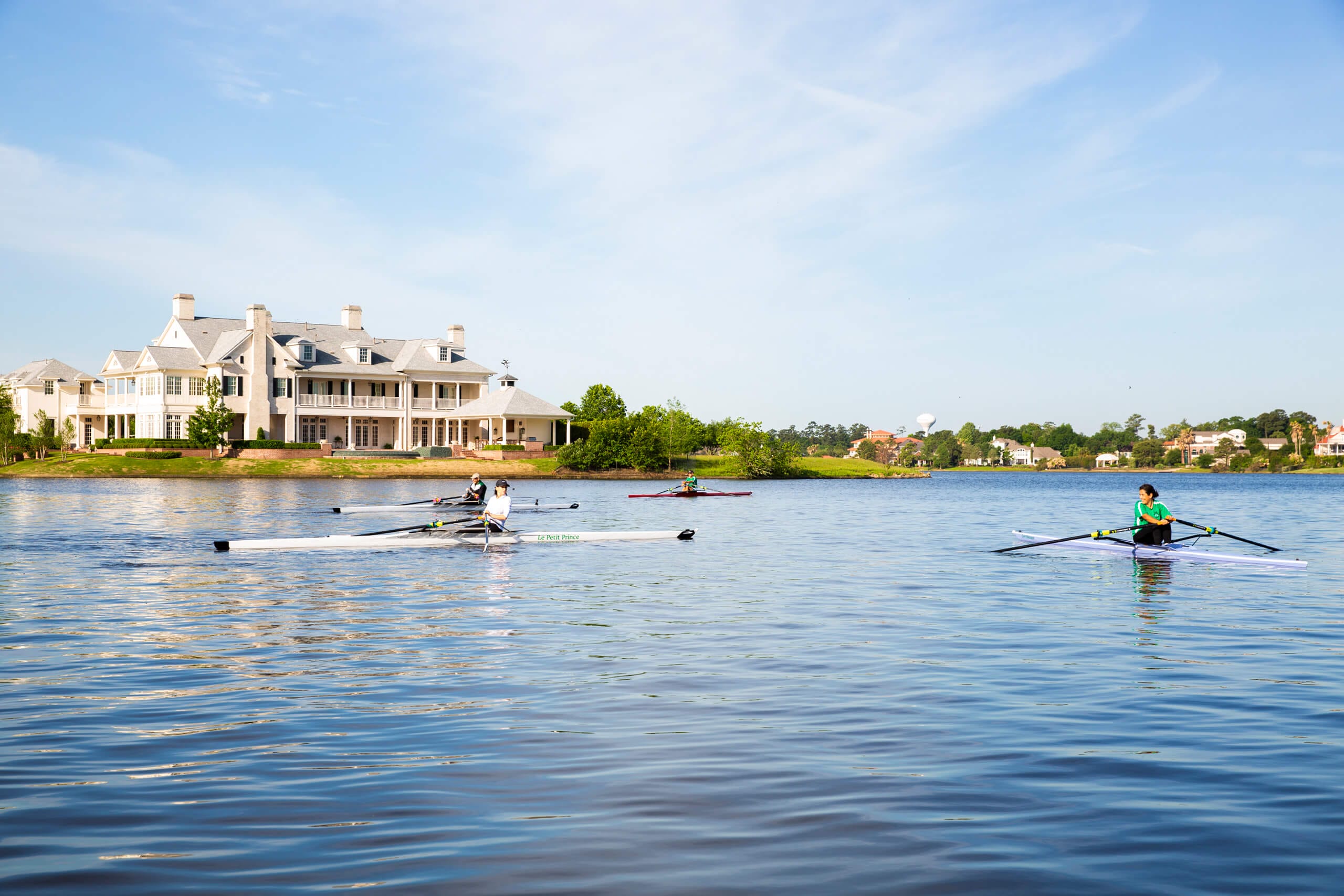 Four rowers meet on the lake in The Woodlands.